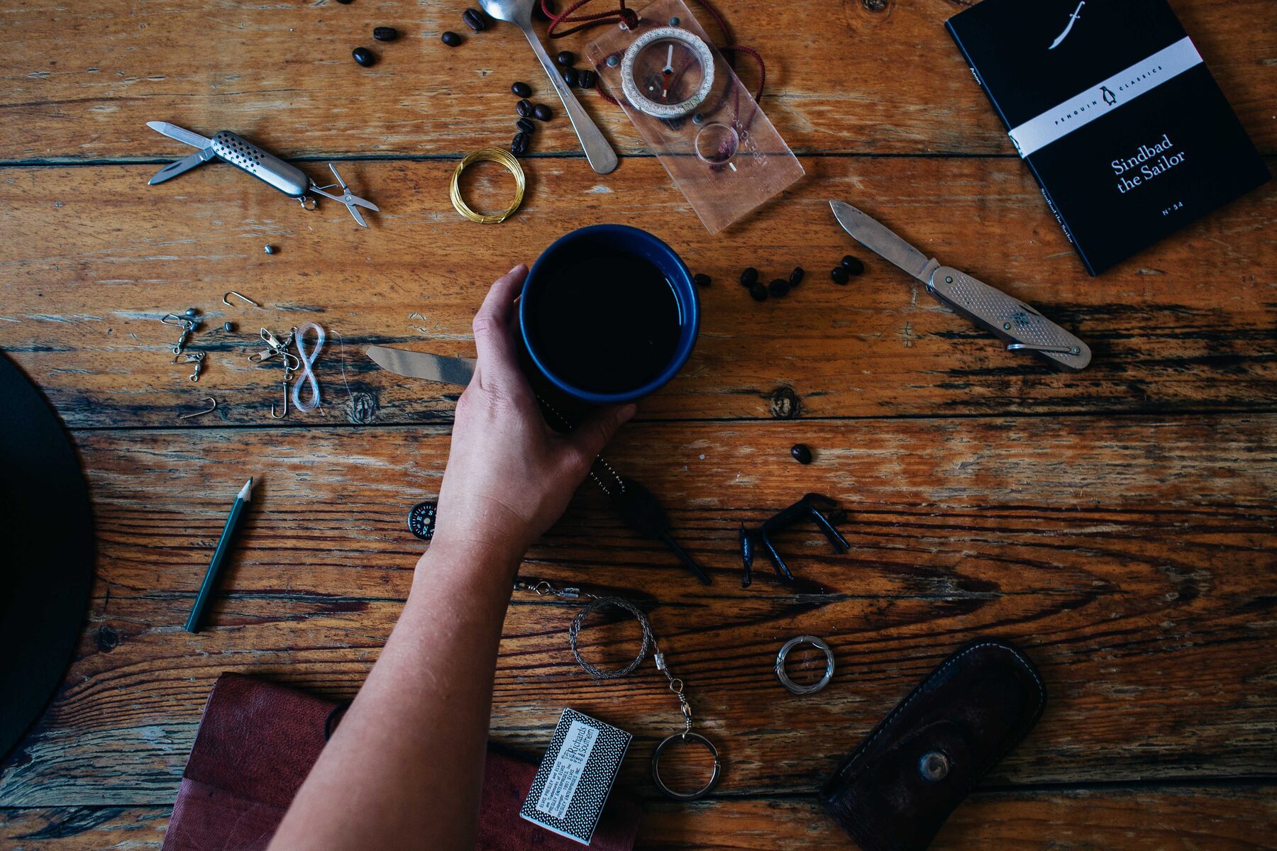 An overhead flat lay of workshop tools and materials arranged on a wooden surface